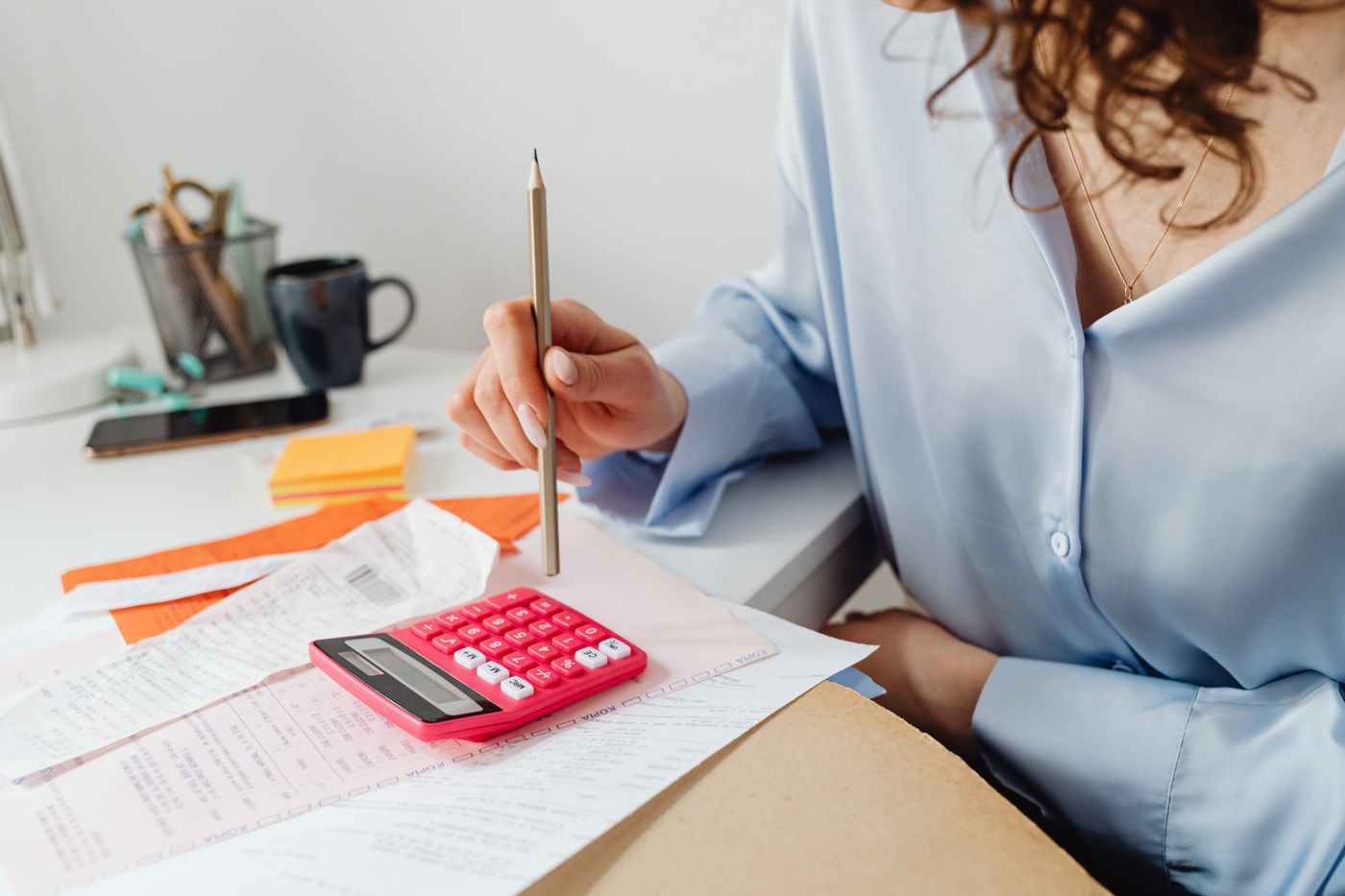 Person reviewing household bills